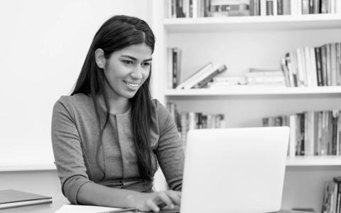 Beautiful south american woman working at computer at office