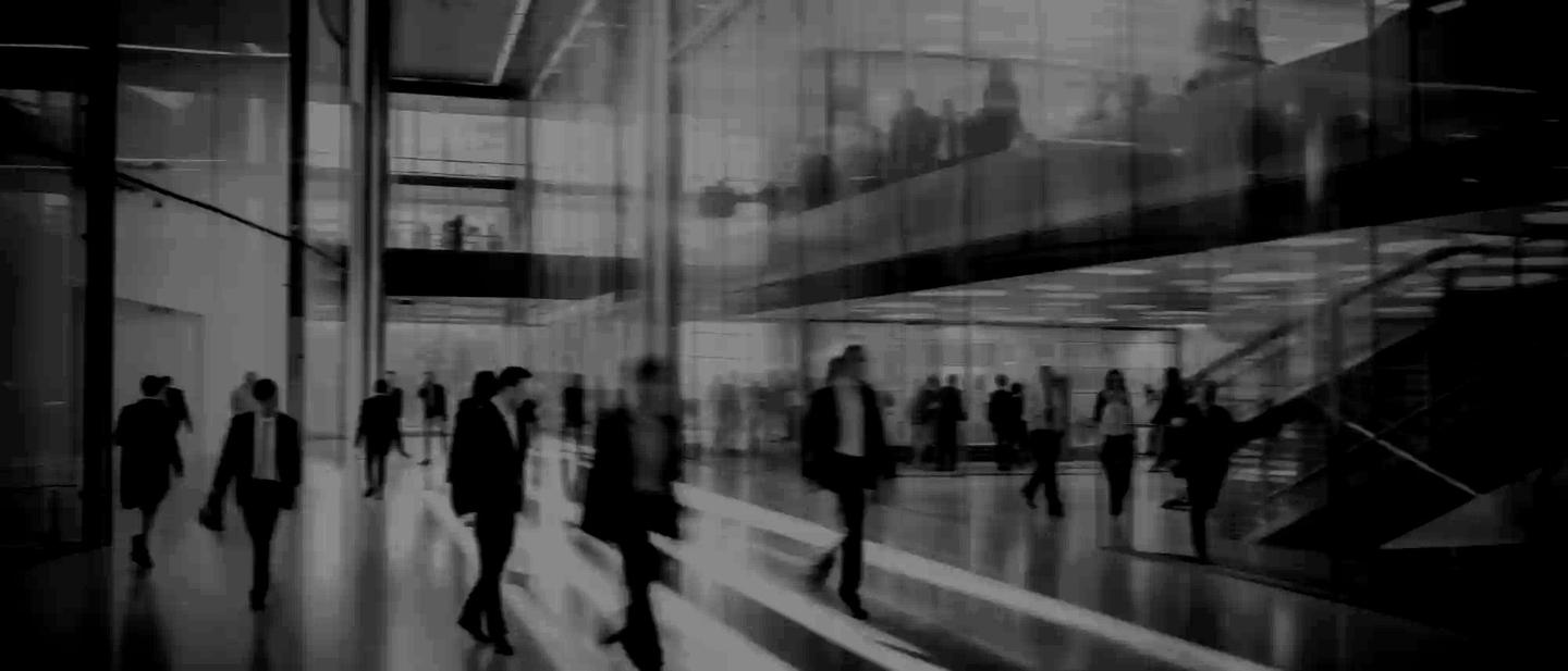 Business people walk in a large office lobby against a cityscape background. Motion blur effect, bright business workplace with people in walking in blurred motion in modern office space