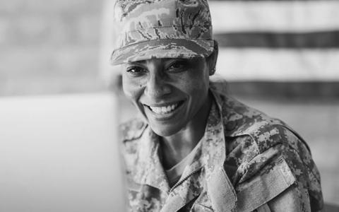 Patriotic female soldier video chatting with her family on a laptop